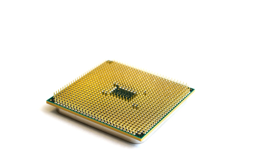 Close-up of CPU Processor Pins on White Background