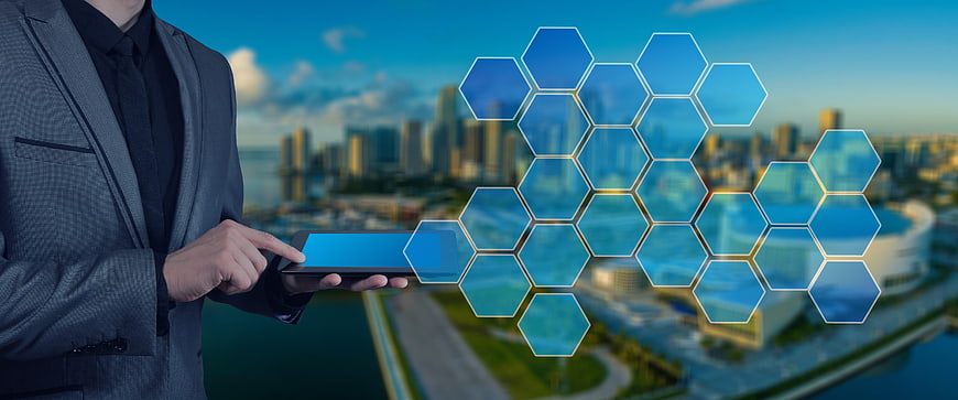 Businessman using tablet with futuristic hexagon network overlay