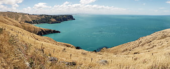 Panoramic View of Golden Hills Overlooking Turquoise Ocean Coastline