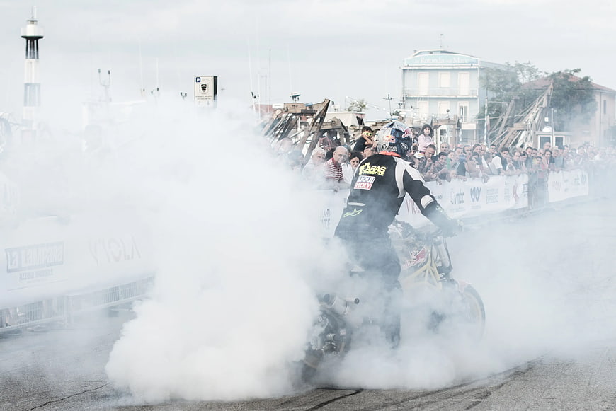 Motorcyclist performing burnout stunt with smoke