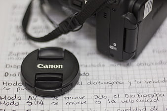 Canon Camera Lens Cap on Handwritten Photography Notes
