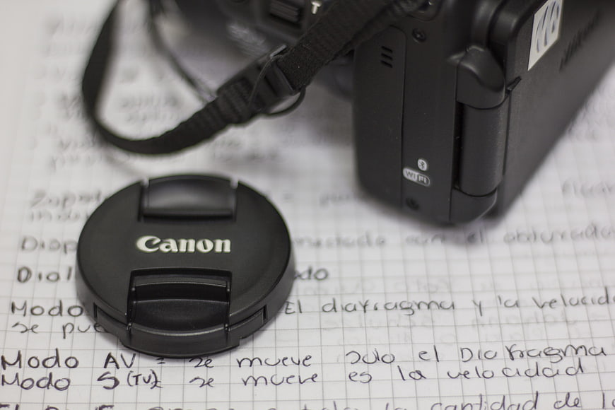 Canon Camera Lens Cap on Handwritten Photography Notes