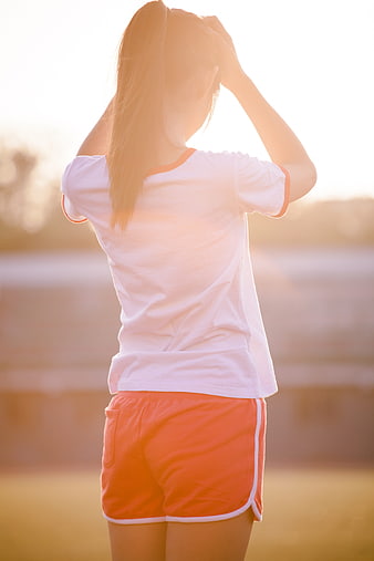 Young Woman in Sportswear at Sunset