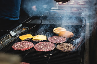 Grilling Beef Burgers and Cheese on Outdoor BBQ Grill