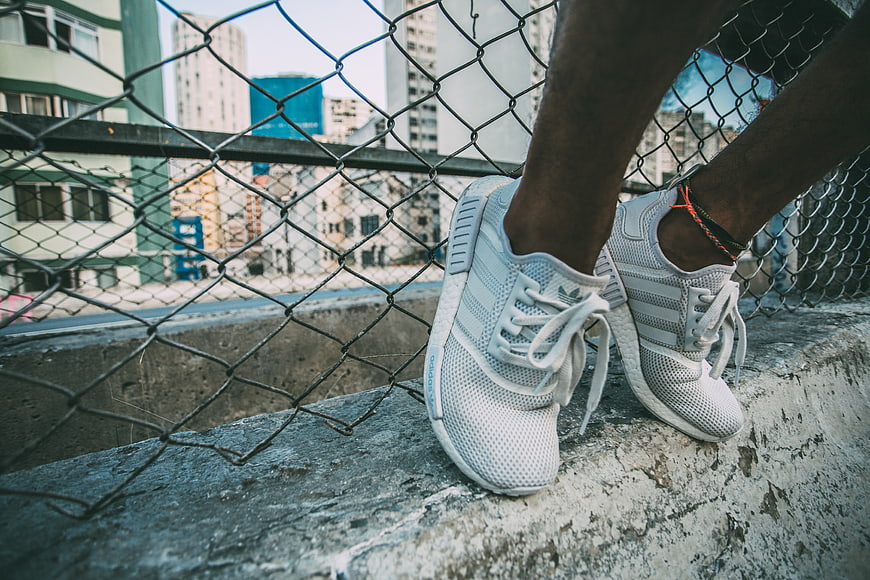 Urban sneakers on concrete ledge with city skyline background