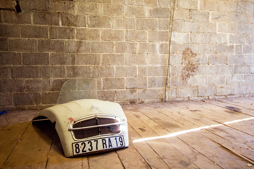 Vintage Citroën 2CV Hood with License Plate in Barn