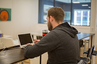 Man working on laptop in modern office workspace