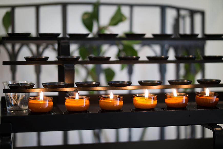 Lit Tea Candles on Church Prayer Stand