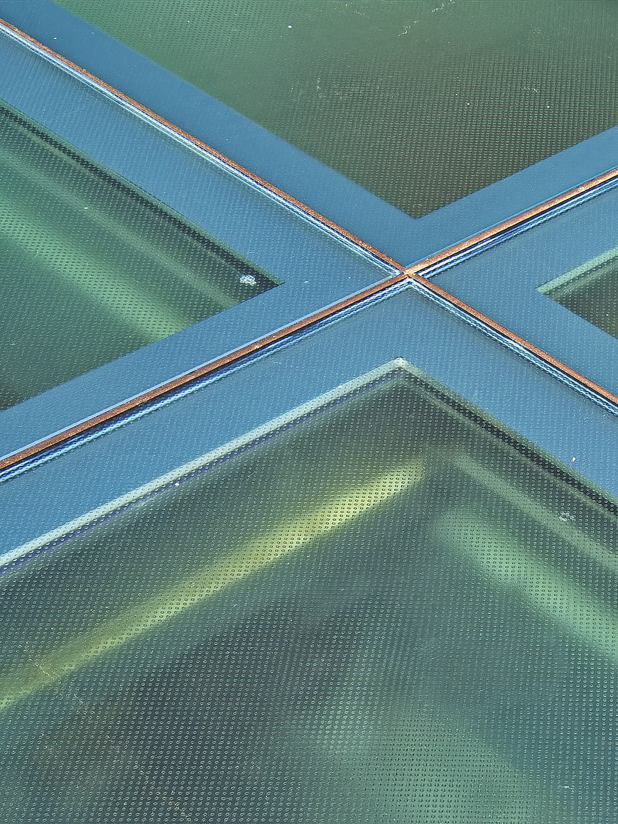 Abstract geometric glass texture with blue and green tones