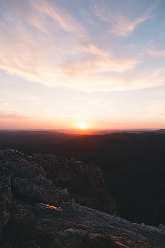 Sunset Over Rocky Mountain Ridge With Pink Clouds