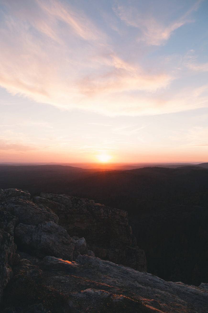 Sunset Over Rocky Mountain Ridge With Pink Clouds