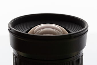 Close-up of camera lens with aperture blades on white background