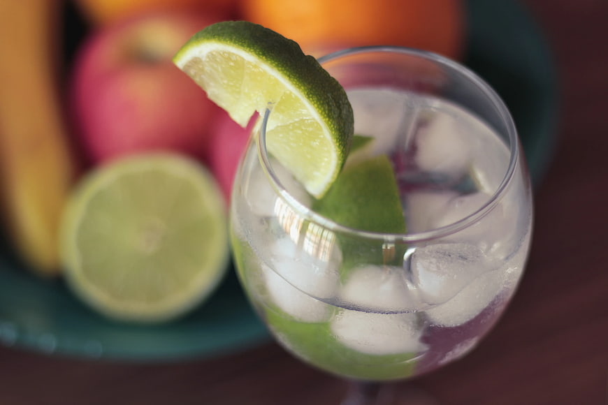Refreshing Lime Drink with Ice and Fresh Fruit Background