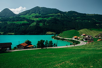 Turquoise Lake and Green Hills in the Alps