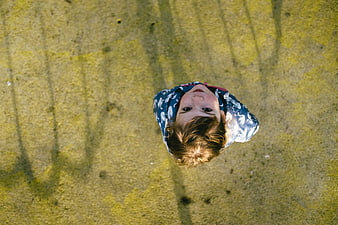 Top-down view of a child looking up at the camera