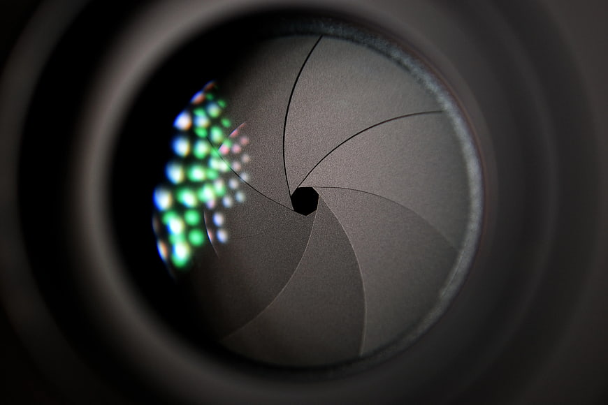 Close-up of Camera Lens Aperture with Bokeh Reflection