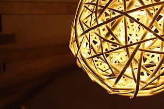 Close-up of glowing woven rattan pendant lamp