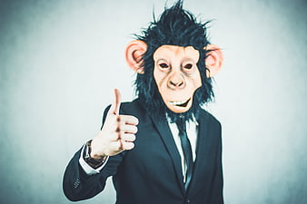 Man in Monkey Mask Giving Thumbs Up in Business Suit