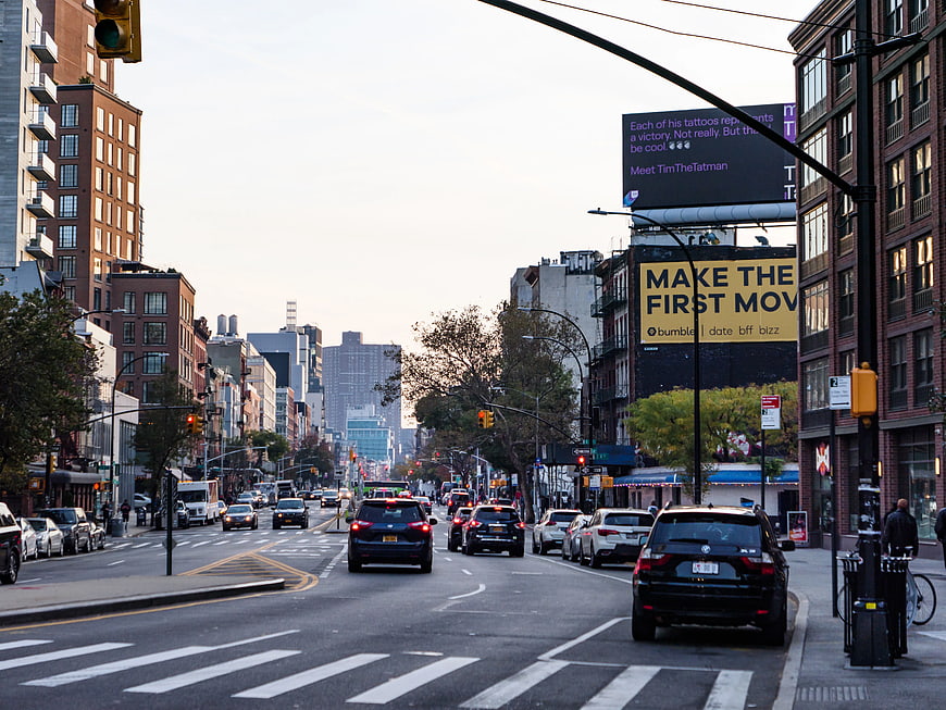 Busy Manhattan Street Scene with Traffic and Billboards