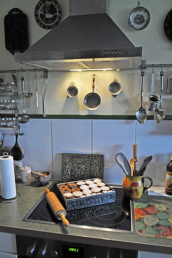 Homemade cookies in decorative tin on kitchen counter