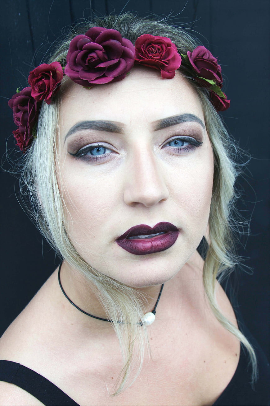 Blonde Woman with Dark Floral Crown and Bold Makeup
