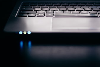 Closeup of Laptop Keyboard and Trackpad in Dark Setting