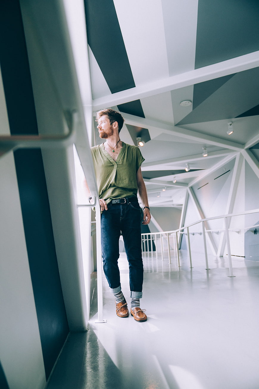 Casual Man Standing in Modern Geometric Architecture