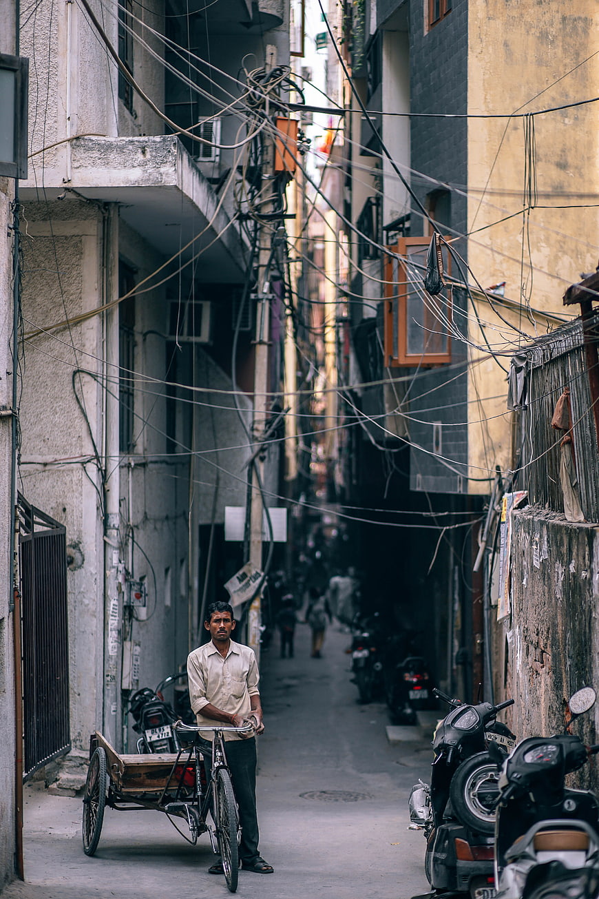 Man with Cycle Rickshaw in Narrow Indian Street