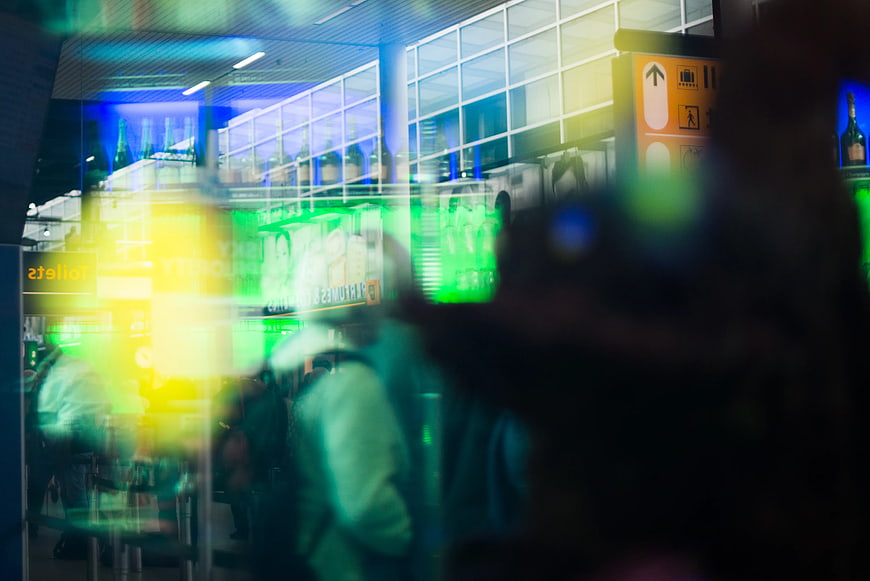 Abstract neon lights and reflections in a busy indoor space