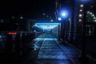 Night view of Amtrak station entrance with blue neon lights