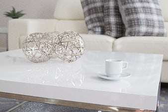 Modern white coffee table with espresso cup and wire decor