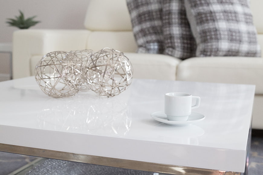 Modern white coffee table with espresso cup and wire decor