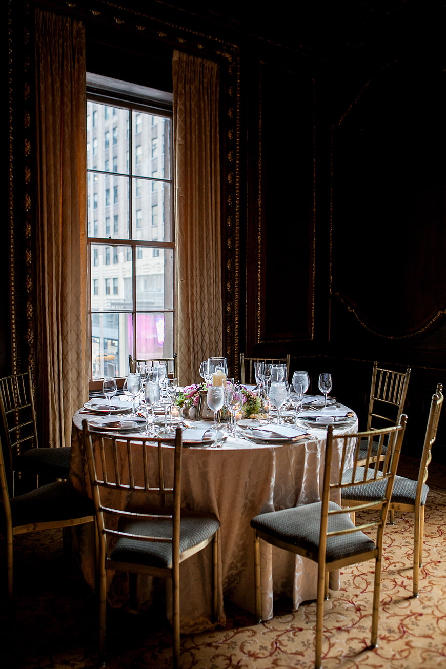 Elegant formal dining table set for a banquet near a window