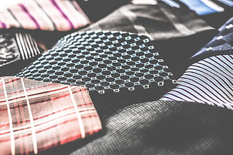Close-up of various patterned neckties and fabric textures