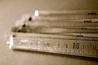 Stack of vintage folding rulers with sepia tone