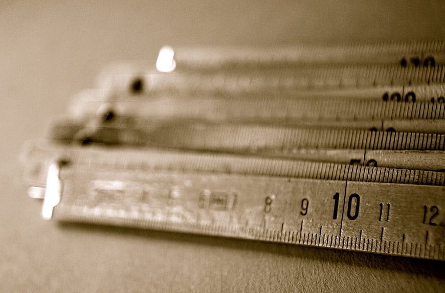Stack of vintage folding rulers with sepia tone