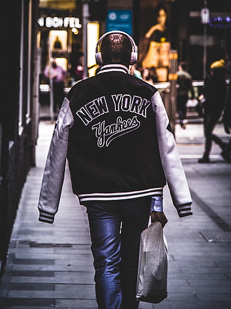 Man in New York Yankees Jacket Walking at Night