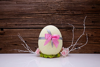 Decorated Easter Egg With Pink Ribbon And Flowers On Wooden Background
