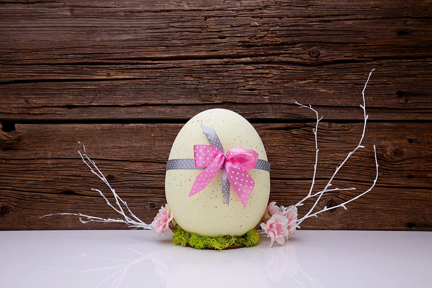 Decorated Easter Egg With Pink Ribbon And Flowers On Wooden Background