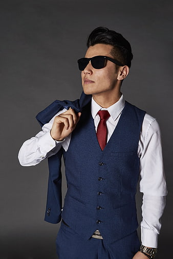 Confident businessman in blue suit and sunglasses