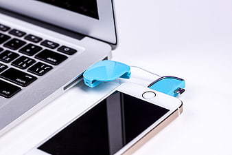 Blue USB Flash Drives Connected to Laptop and Smartphone