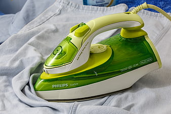 Green Philips EcoCare Steam Iron on White Fabric