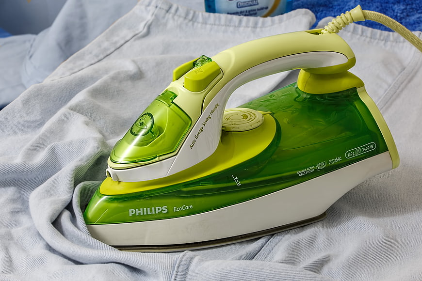 Green Philips EcoCare Steam Iron on White Fabric