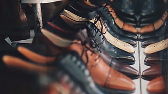 Rows of elegant leather dress shoes in a shop display