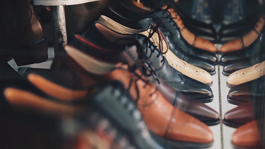 Rows of elegant leather dress shoes in a shop display