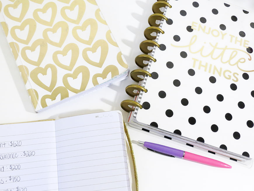 Flat lay of gold heart and polka dot notebooks with pen