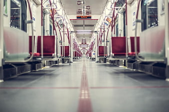 Empty subway train interior with red seats and perspective view