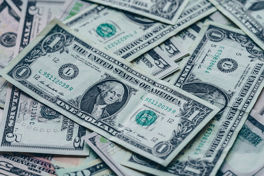 Scattered US Dollar Bills Close-Up Background