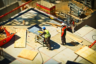 High Angle View of Construction Workers Using Table Saw