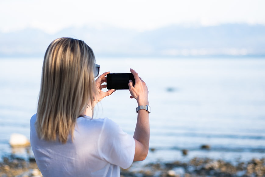 Woman Taking Photo of Ocean View with Smartphone